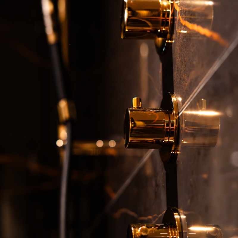 Golden showeringknobs from the wall