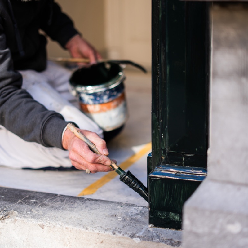 painting the door of an historical buiding