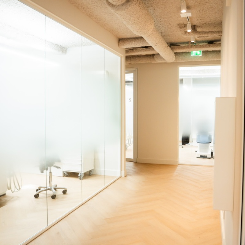 Corridor with glass walls alongside treatment rooms 1 and 2
