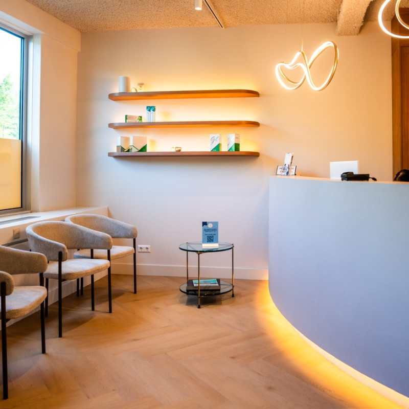 Waiting area with chairs by the window and a reception desk