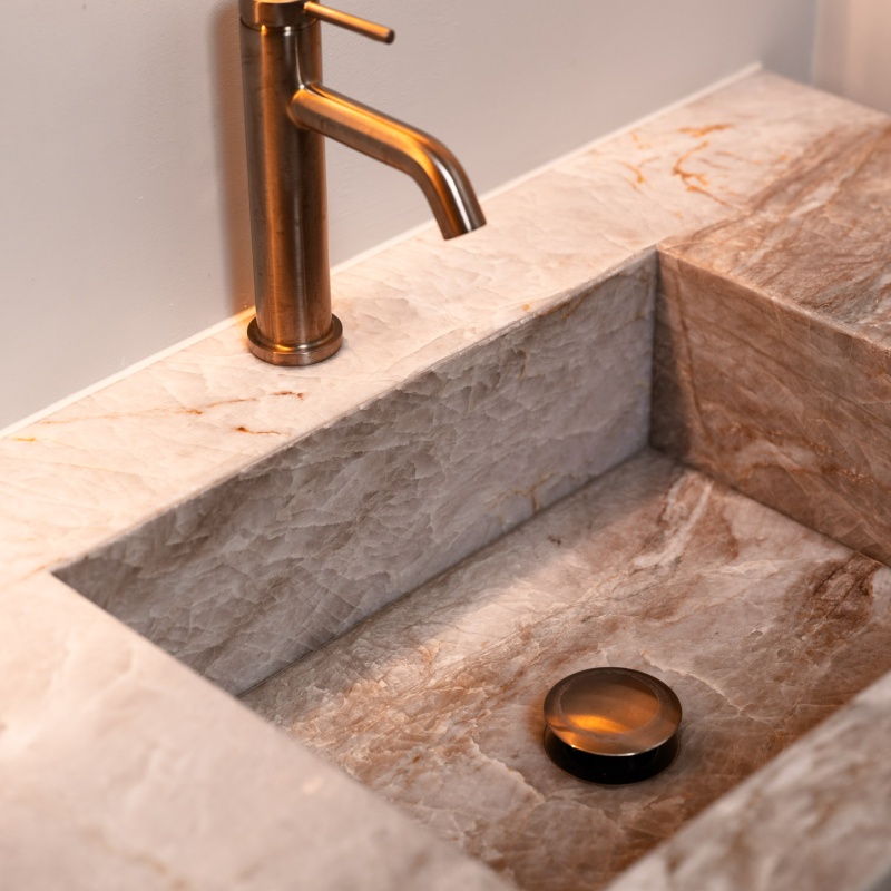 Bathroom detail with natural stone washbasin